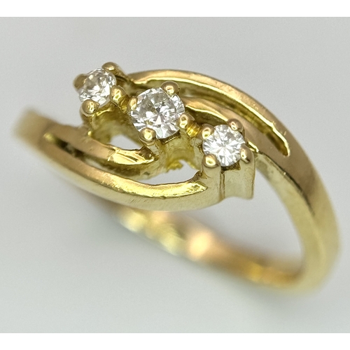 193 - AN 18K YELLOW GOLD THREE STONE DIAMOND CROSSOVER RING - 2.8G. SIZE G. A/S 1219.