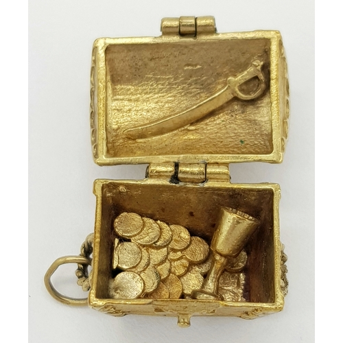 158 - A 9K YELLOW GOLD PIRATES TREASURE CHEST CHARM WHICH OPENS TO REVEAL SWORD, GOBLET AND TRREASURE. 6.8... 