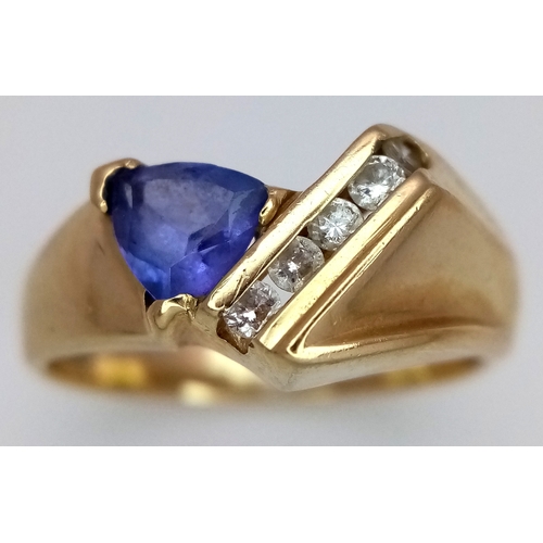 114 - A 14K Yellow Gold Diamond and Tanzanite Abstract Ring. Trillion cut tanzanite with channel set diamo... 