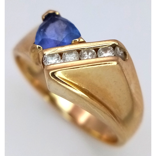 114 - A 14K Yellow Gold Diamond and Tanzanite Abstract Ring. Trillion cut tanzanite with channel set diamo... 