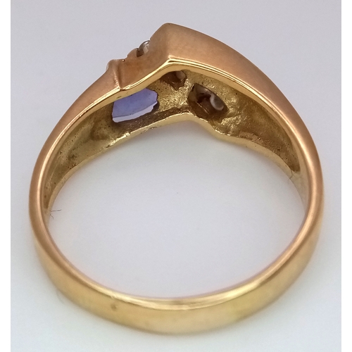 114 - A 14K Yellow Gold Diamond and Tanzanite Abstract Ring. Trillion cut tanzanite with channel set diamo... 