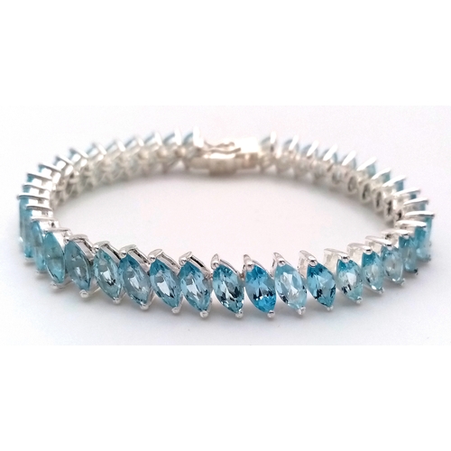 219 - A Marquise Cut Blue Topaz Tennis Bracelet. Set in 925 Silver.
18cm. CD-1690