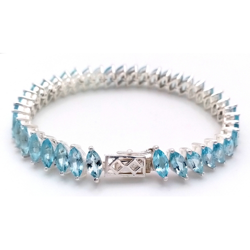 219 - A Marquise Cut Blue Topaz Tennis Bracelet. Set in 925 Silver.
18cm. CD-1690