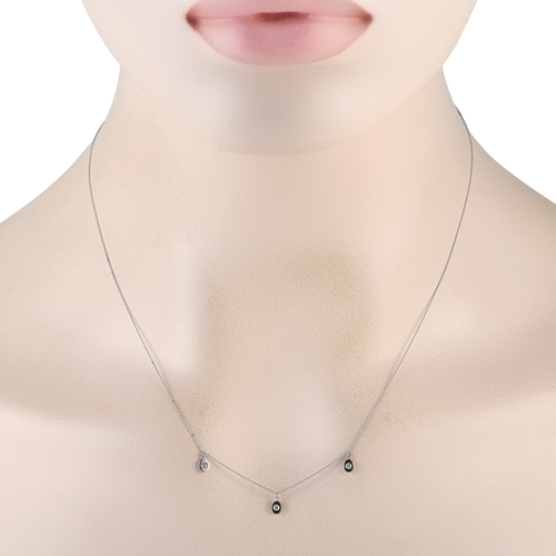 295 - A 14K White Gold 0.06ct Diamond Station Necklace. A series of 14K white gold pendants make this neck... 