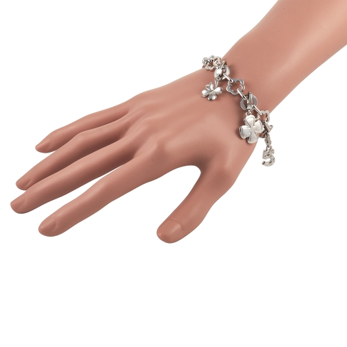 82 - A Chanel Camelia 18K White Gold Four Charm Bracelet. The bracelet is made up of alternating floral a... 