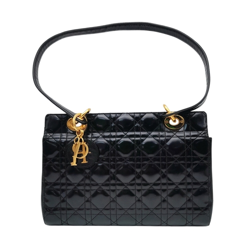 199 - A Christian Dior Black Patent Leather Bag. Black leather exterior with gold-toned hardware and magne... 