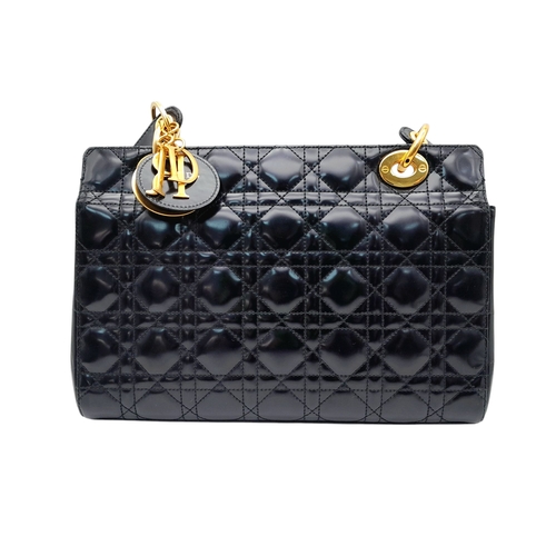 199 - A Christian Dior Black Patent Leather Bag. Black leather exterior with gold-toned hardware and magne... 