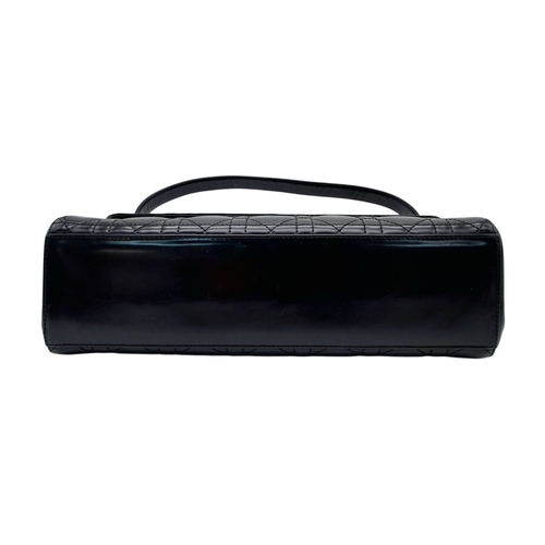 199 - A Christian Dior Black Patent Leather Bag. Black leather exterior with gold-toned hardware and magne... 