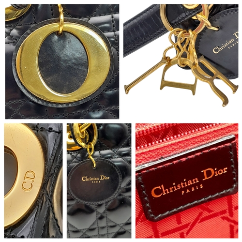 199 - A Christian Dior Black Patent Leather Bag. Black leather exterior with gold-toned hardware and magne... 