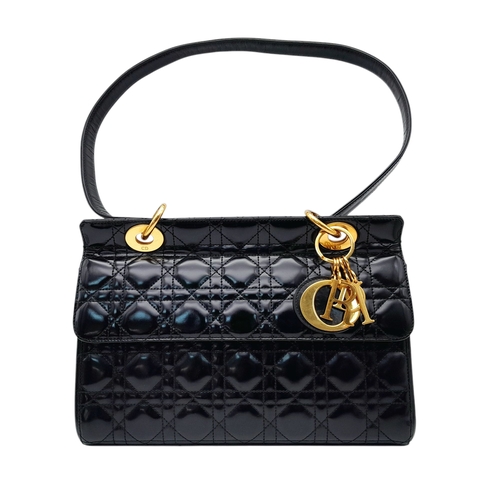 199 - A Christian Dior Black Patent Leather Bag. Black leather exterior with gold-toned hardware and magne... 