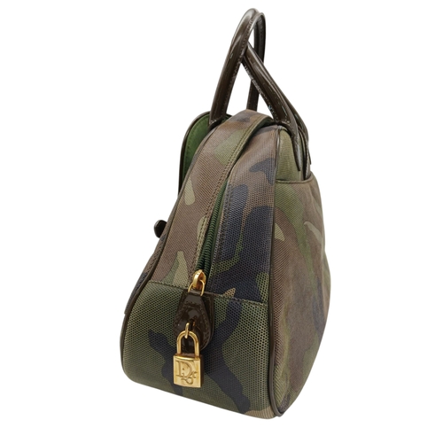 213 - A Christian Dior Camouflage Boston Bag. Olive green canvas exterior with leather trim, gold-toned ha... 