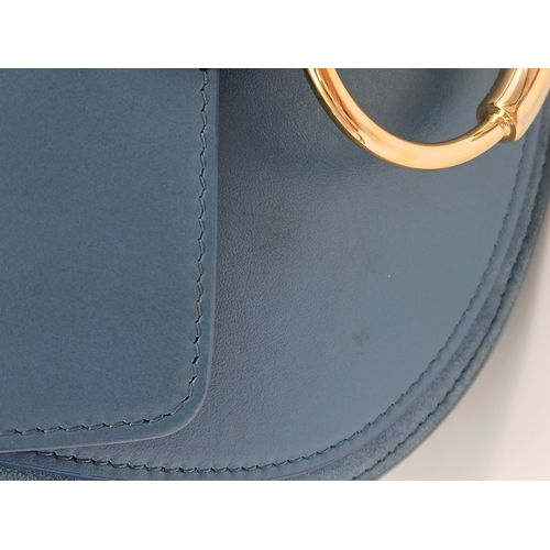 263 - A Chloé Blue Leather Tess Bag. Blue leather exterior with gold-toned hardware, top handle, detachabl... 