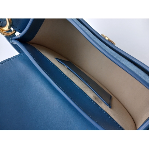 263 - A Chloé Blue Leather Tess Bag. Blue leather exterior with gold-toned hardware, top handle, detachabl... 