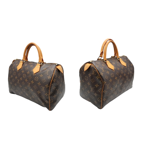 396 - A Louis Vuitton Monogram Canvas Speedy 30 Bag. Brown coated canvas exterior with gold-toned hardware... 