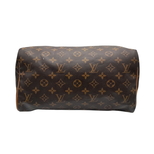 396 - A Louis Vuitton Monogram Canvas Speedy 30 Bag. Brown coated canvas exterior with gold-toned hardware... 