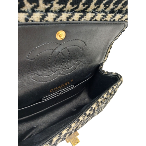 46 - A Chanel Black and Cream Houndstooth Tweed Flap Bag. Black and cream tweed exterior with gold-toned ... 