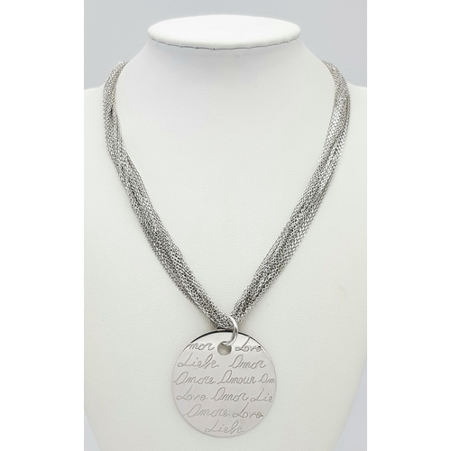 495 - A STERLING SILVER MULTI STRAND NECKLACE - WITH PENDANT ENGRAVED WITH THE WORD 'LOVE' IN MANY LANGUAG... 