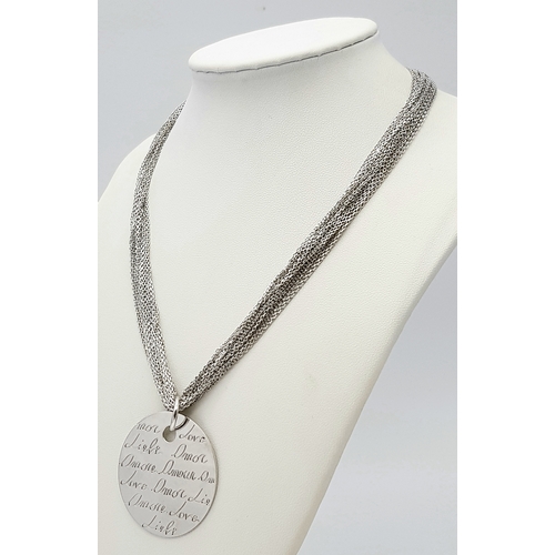 495 - A STERLING SILVER MULTI STRAND NECKLACE - WITH PENDANT ENGRAVED WITH THE WORD 'LOVE' IN MANY LANGUAG... 