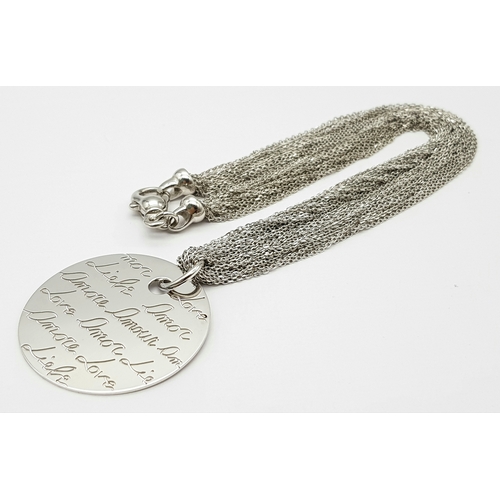 495 - A STERLING SILVER MULTI STRAND NECKLACE - WITH PENDANT ENGRAVED WITH THE WORD 'LOVE' IN MANY LANGUAG... 