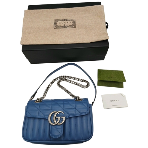 32 - A Gucci Blue Matelassé Leather GG Marmont Shoulder Bag. Blue matelassé leather exterior with silver-... 