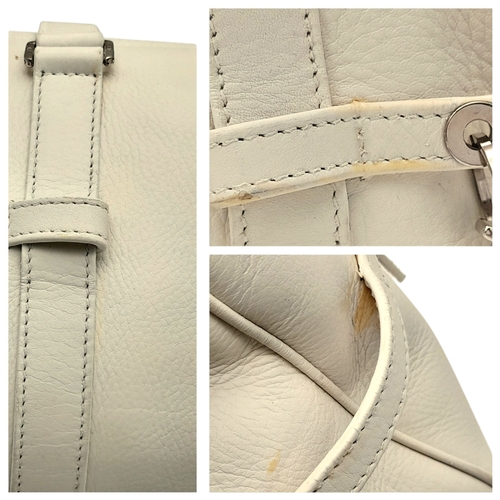 375 - A Christian Dior White Leather Shoulder Bag. White grained leather exterior with silver-toned hardwa... 