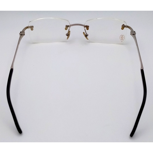 438 - A Pair of Designer Cartier Eyeglasses. Comes with pouch, extra Cartier box, case, certificate and ex... 