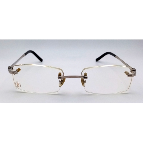 438 - A Pair of Designer Cartier Eyeglasses. Comes with pouch, extra Cartier box, case, certificate and ex... 