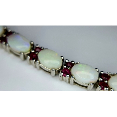 444 - A Sterling Silver Opal and Ruby Set Tennis Bracelet-20cm Length. The Bracelet is set with Twenty Thr... 