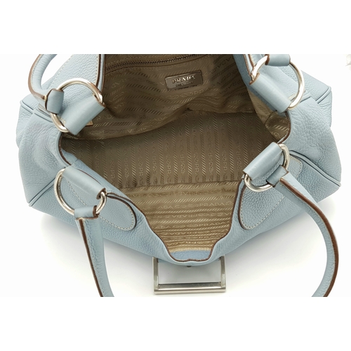 445 - A Prada Light Blue Leather Shoulder Bag. Light blue pebbled leather exterior with gold-toned hardwar... 