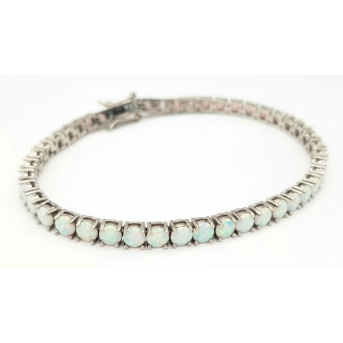 486 - A Sterling Silver Opal Set Tennis Bracelet-19cm Length. The Bracelet is set with Forty Five 4mm Roun... 