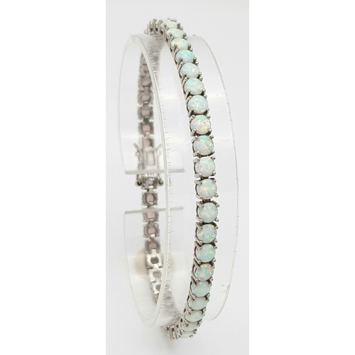 486 - A Sterling Silver Opal Set Tennis Bracelet-19cm Length. The Bracelet is set with Forty Five 4mm Roun... 