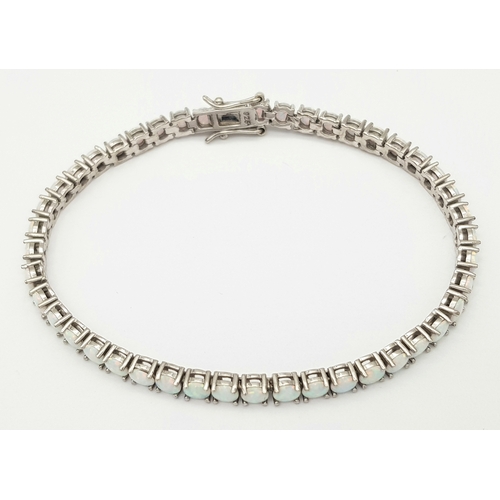 486 - A Sterling Silver Opal Set Tennis Bracelet-19cm Length. The Bracelet is set with Forty Five 4mm Roun... 