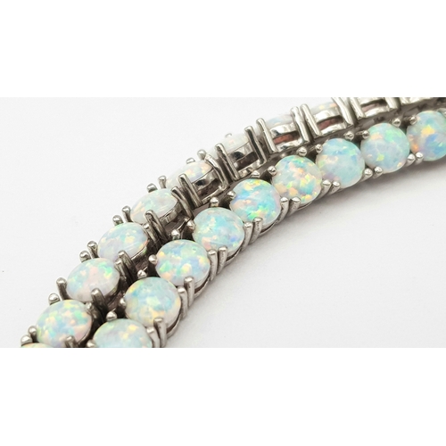 486 - A Sterling Silver Opal Set Tennis Bracelet-19cm Length. The Bracelet is set with Forty Five 4mm Roun... 