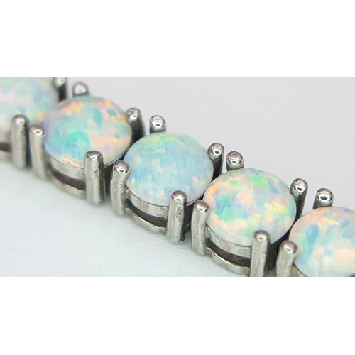 486 - A Sterling Silver Opal Set Tennis Bracelet-19cm Length. The Bracelet is set with Forty Five 4mm Roun... 