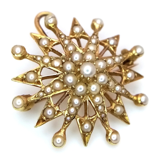 323 - An Antique Mid Karat (14/15K) Gold  Seed Pearl Star Burst Brooch/Pendant. 2.5cm. 3.18g