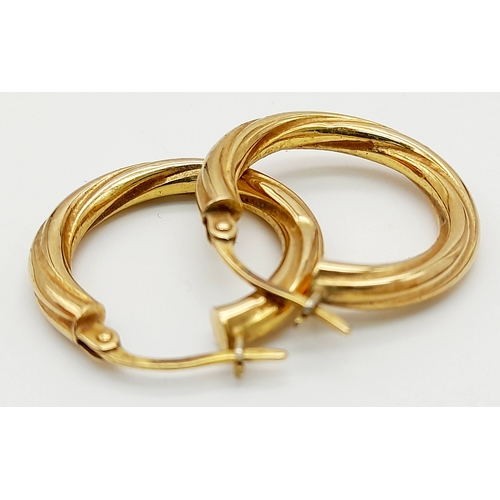 49 - Classic pair of 9 CARAT GOLD TWIST HOOP EARRINGS. Full UK hallmark. 1.6 grams. 2 cm Diameter.