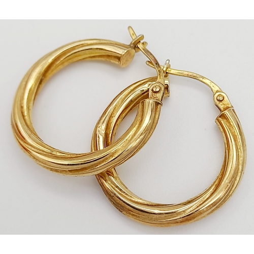 49 - Classic pair of 9 CARAT GOLD TWIST HOOP EARRINGS. Full UK hallmark. 1.6 grams. 2 cm Diameter.