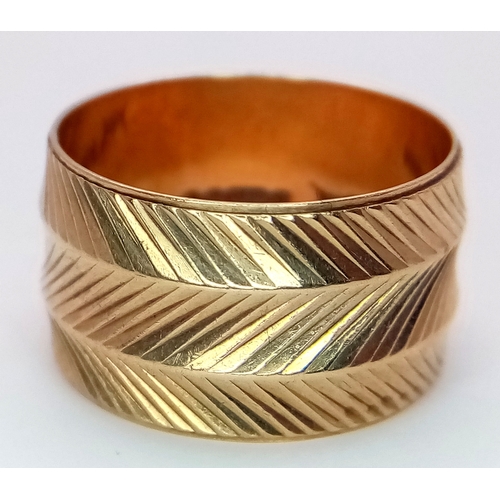 8 - A Vintage 9K Yellow Gold Band Ring. Geometric decoration. 12mm width. Size P. 5g.