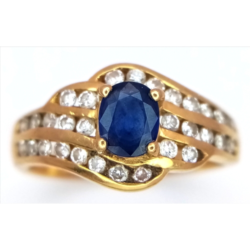 68 - An 18K Yellow Gold Sapphire and Diamond Ring. Central sapphire with a multiple diamond channel surro... 