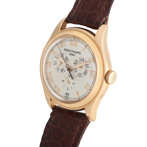 272 - An 18K Yellow Gold Patek Philippe Annual Calendar Watch. 37mm case and round bezel with a brown leat... 