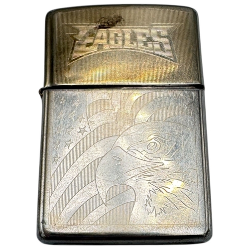 1733 - A vintage US Zippo Eagles Engraved Lighter. Some surface wear and patina consistent with age and use... 