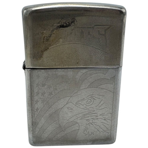 1733 - A vintage US Zippo Eagles Engraved Lighter. Some surface wear and patina consistent with age and use... 