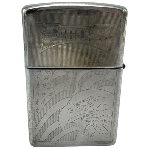 1733 - A vintage US Zippo Eagles Engraved Lighter. Some surface wear and patina consistent with age and use... 