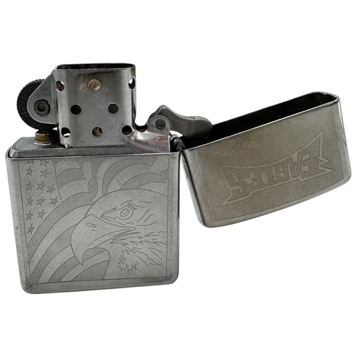 1733 - A vintage US Zippo Eagles Engraved Lighter. Some surface wear and patina consistent with age and use... 