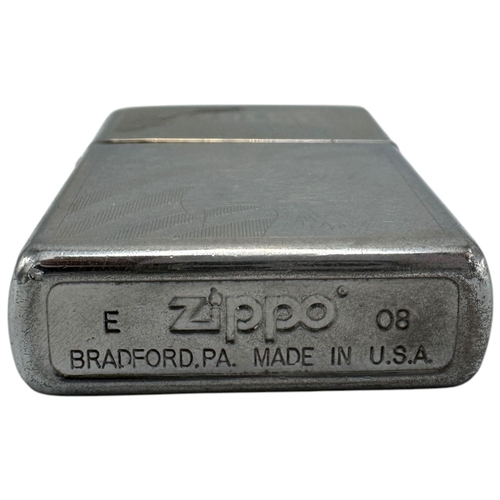 1733 - A vintage US Zippo Eagles Engraved Lighter. Some surface wear and patina consistent with age and use... 