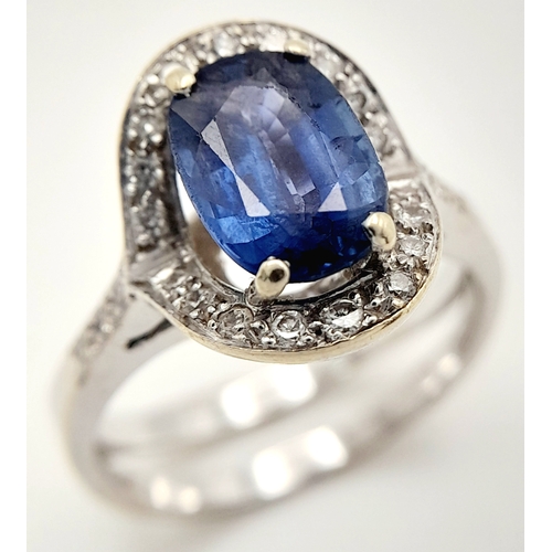 39 - AN 18K WHITE GOLD  RING WITH CENTRE SAPPHIRE AND SURROUNDED BY DIAMONDS .