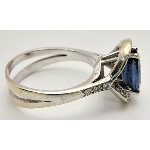 39 - AN 18K WHITE GOLD  RING WITH CENTRE SAPPHIRE AND SURROUNDED BY DIAMONDS .