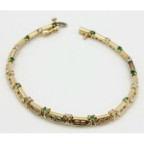 499 - A 14K GOLD BRACELET WITH DIAMONDS AND EMERALDS .    10gms     18cms