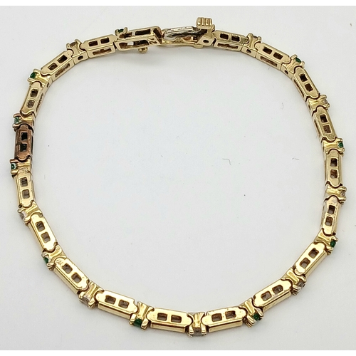 499 - A 14K GOLD BRACELET WITH DIAMONDS AND EMERALDS .    10gms     18cms