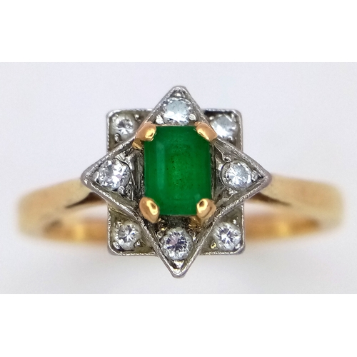 506 - AN 18K GOLD RINF WITH A CENTRAL EMERALD SURROUNDED BY DIAMONDS SET IN PLATINUM.    5gms    size Q